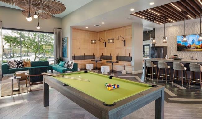 Resident lounge with a pool table and seating areas at Zaterra apartments, Chandler, AZ.