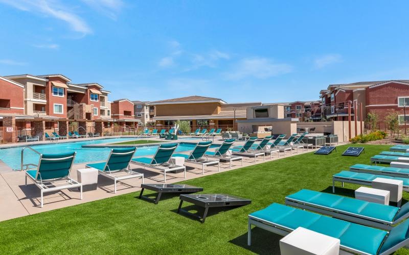 a pool with lounge chairs around it