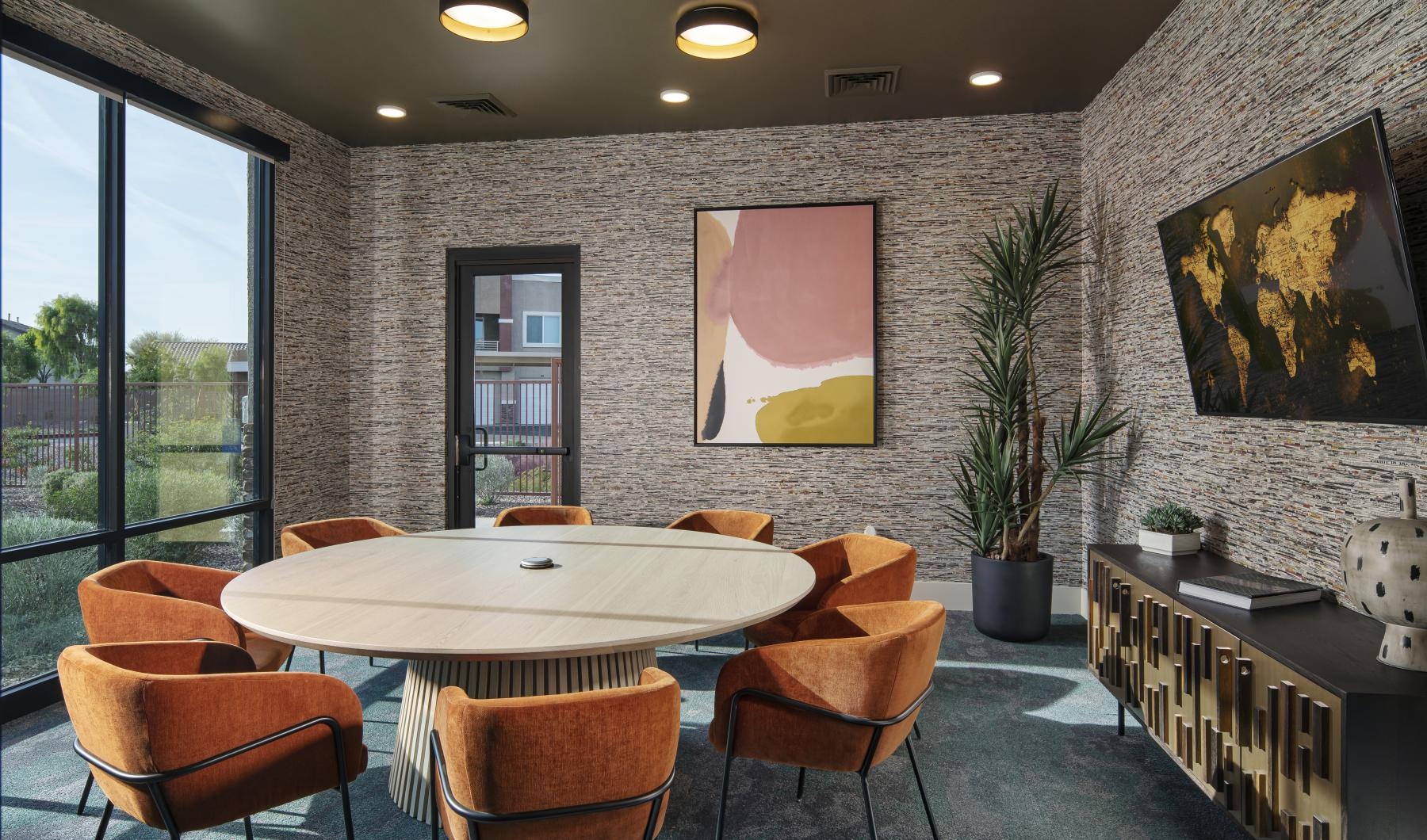 a clubhouse room with a table and chairs