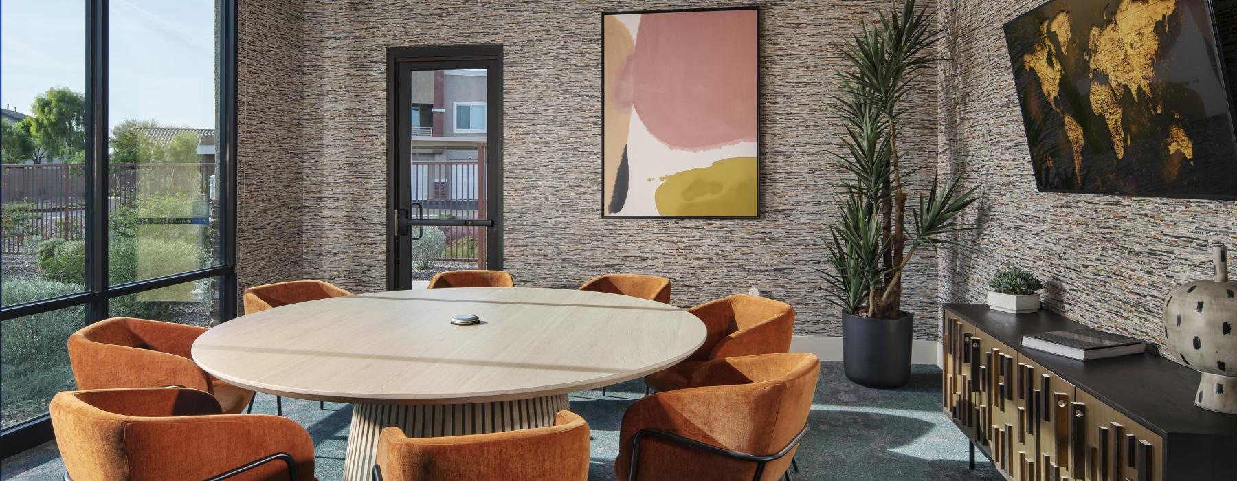 a clubhouse room with a table and chairs