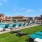 a pool with lounge chairs around it
