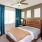 a bedroom with a bed and a fan